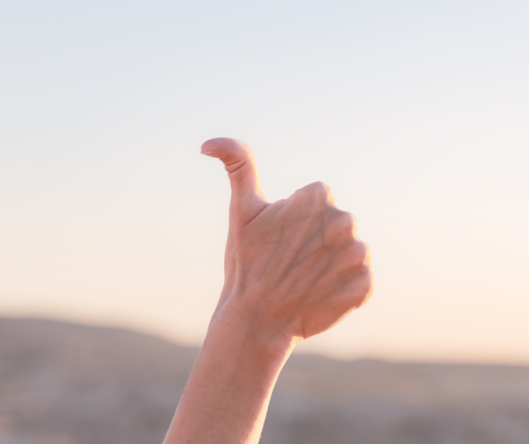 A person who is double jointed giving a thumbs up showing how far the thumb can go back