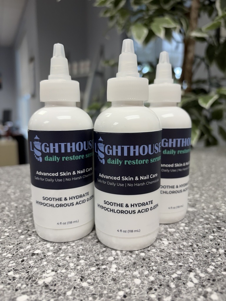 Three bottles of Lighthouse Daily Restore Serum on the counter at Lighthouse Foot and Ankle Center in Scarborough, Maine